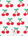 Premium organic cotton pajamas with cherry print, stylish red trim, slip-on neckline, snap buttons, soft GOTS-certified fabric by Toby Tiger at brixbailey.com