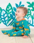 Premium baby sleepwear with lion print, 100% organic cotton, soft and comfortable, fully buttoned for easy diaper changes, GOTS certified by Toby Tiger at brixbailey.com