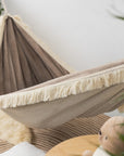 Feather Dream Hammock for Kids - Cozy & Safe Handmade Retreat with Magical Fringes and Soft Beige Fabric by Sówka at www.brixbailey.com