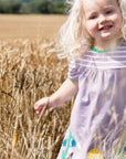 Organic Kids T-Shirt Dress with Floral Appliques, Striped Top, and Lilac Background for Spring by Toby Tiger at brixbailey.com