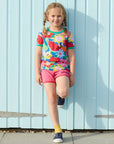 Premium baby short sleeve t-shirt with floral and fruit print, soft organic cotton, snap button neck, stylish green trim by Toby Tiger at brixbailey.com