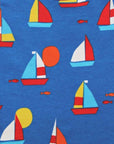 Premium organic cotton kids summer T-shirt with sailboat print, stylish red trim, deep blue background, playful fish details, GOTS certified, easy snap neck closure by Toby Tiger at brixbailey.com