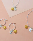 Luxury sterling silver sun and moon earrings with Murano glass charm, stylish hoops for day to night by Lezzeri at brixbailey.com