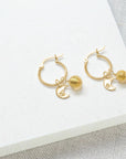 Luxury gold vermeil sun and moon hoop earrings with Murano glass charm, stylish celestial jewelry for all occasions by Lezzeri at brixbailey.com