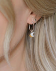 Luxury sterling silver hoops with crescent moon and Murano glass sun charm, elegant day to night earrings by Lezzeri at brixbailey.com