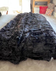 Luxury obsidian black shearling throw, premium Toscana sheepskin rug or bed throw, handcrafted sustainable Tuscan shearling by Wildash London at brixbailey.com