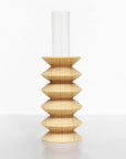 playful beech wood totem vase on a sunlit windowsill with a single cheerful flower