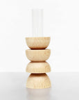 playful modern totem vase with a single bright flower in a sunlit room