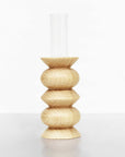 a soft-lit beech wood totem vase with a glass insert on a cozy home shelf