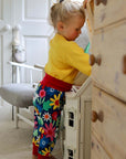 Premium organic cotton kids yoga pants with bold floral print, dark blue with snowdrops daisies and tulips, comfortable waistband and cuffs by Toby Tiger at brixbailey.com