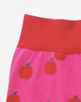 Premium organic cotton kids yoga pants with apple print, stylish red and pink contrast trim, soft GOTS-certified fabric by Toby Tiger at brixbailey.com
