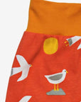 Women's organic cotton yoga pants with seagull print by Toby Tiger in vibrant orange at www.brixbailey.com