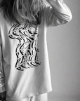 Luxury oversized off-white long sleeve with matte black graphics, premium 200 gsm organic cotton, handcrafted limited edition unisex top by WWOOLLFF CO. at brixbailey.com