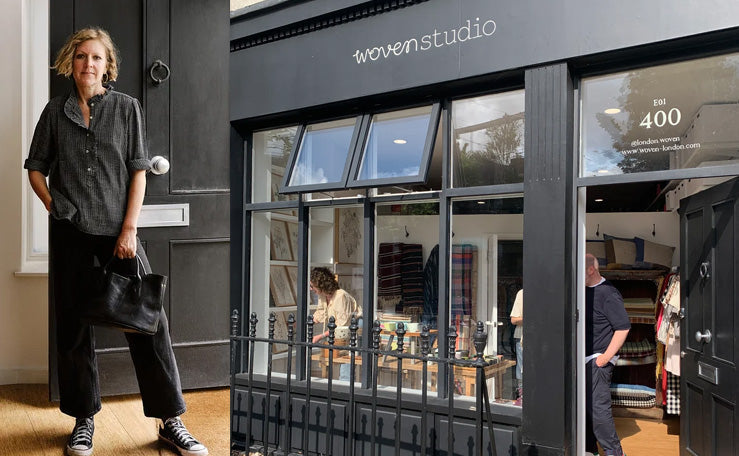 The Woven London shopfront on a city street, with a person walking past the window