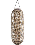 Handwoven wicker lantern with intricate rattan weave, creating warm light patterns, rustic brown home decor. by sostter at brixbailey.com