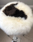 Luxury British sheepskin seat cover, premium 100% natural round hide, white and dark brown, 35cm diameter, therapeutic hypoallergenic fur by Wildash London at brixbailey.com