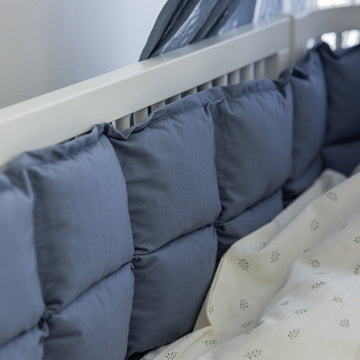 Premium organic cotton kapok bumper in forest lake blue, soft hypoallergenic natural fiber, breathable heat-regulating, fits standard 60x120cm cot beds by Ella James at brixbailey.com
