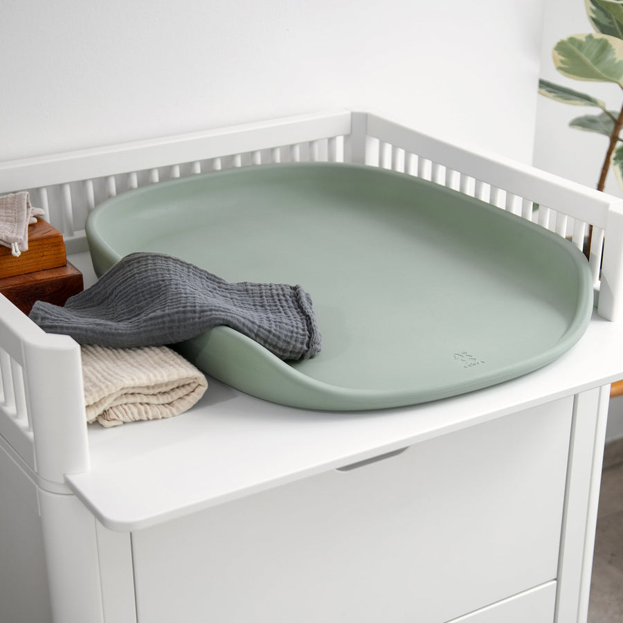 Premium Sebra changing mat in seagrass green, stylish Scandinavian design, soft water-repellent surface, safe high edges, easy to clean by Ella James at brixbailey.com