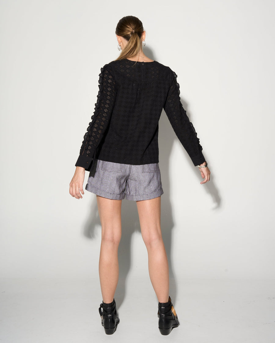 Luxury black ruffled blouse with lace inserts, puff sleeves, and romantic eyelet fabric, best-selling edgy romantic top by GILD at brixbailey.com