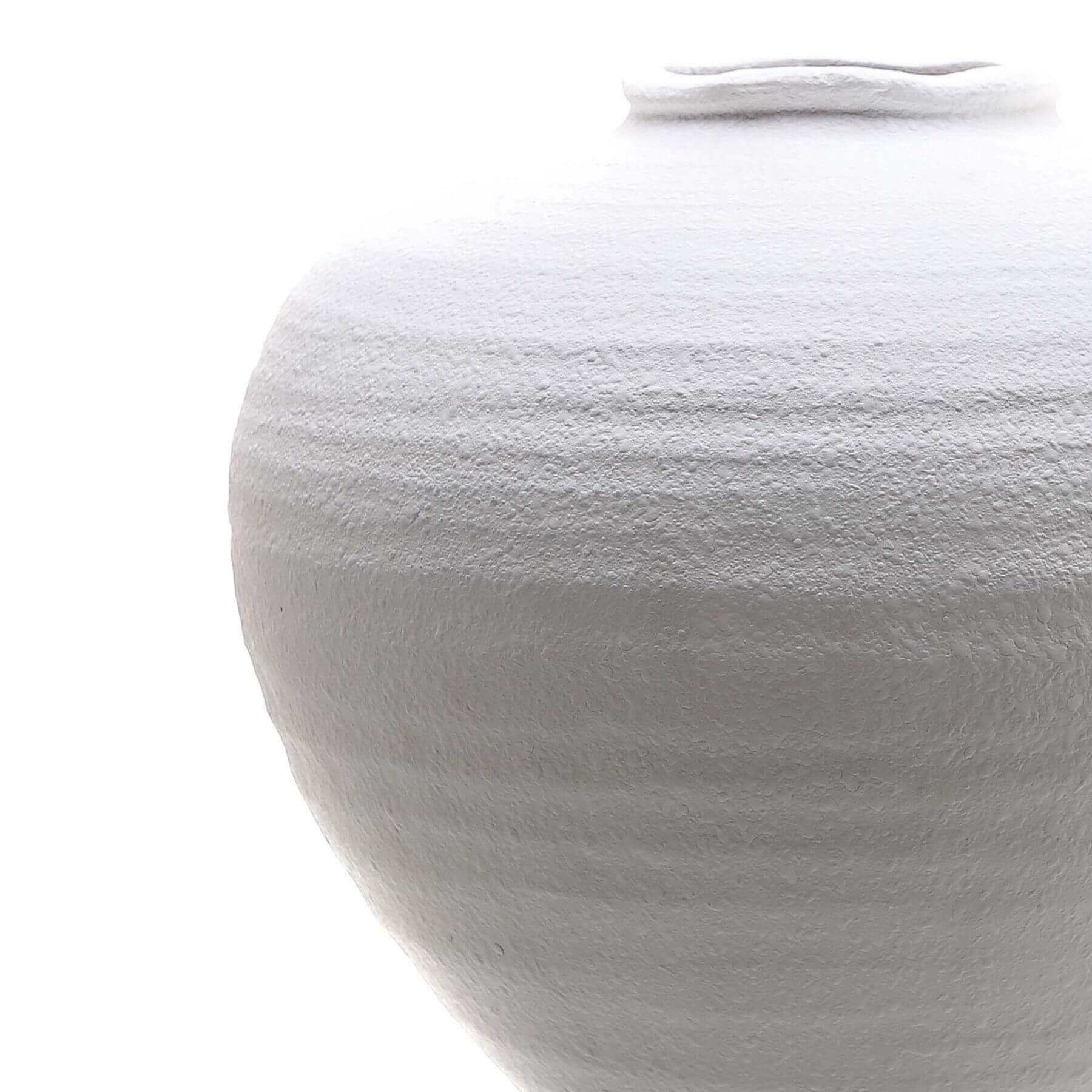 Minimalist white ceramic vase with sculptural silhouette, perfect for floral arrangements in modern decor. by sostter at brixbailey.com