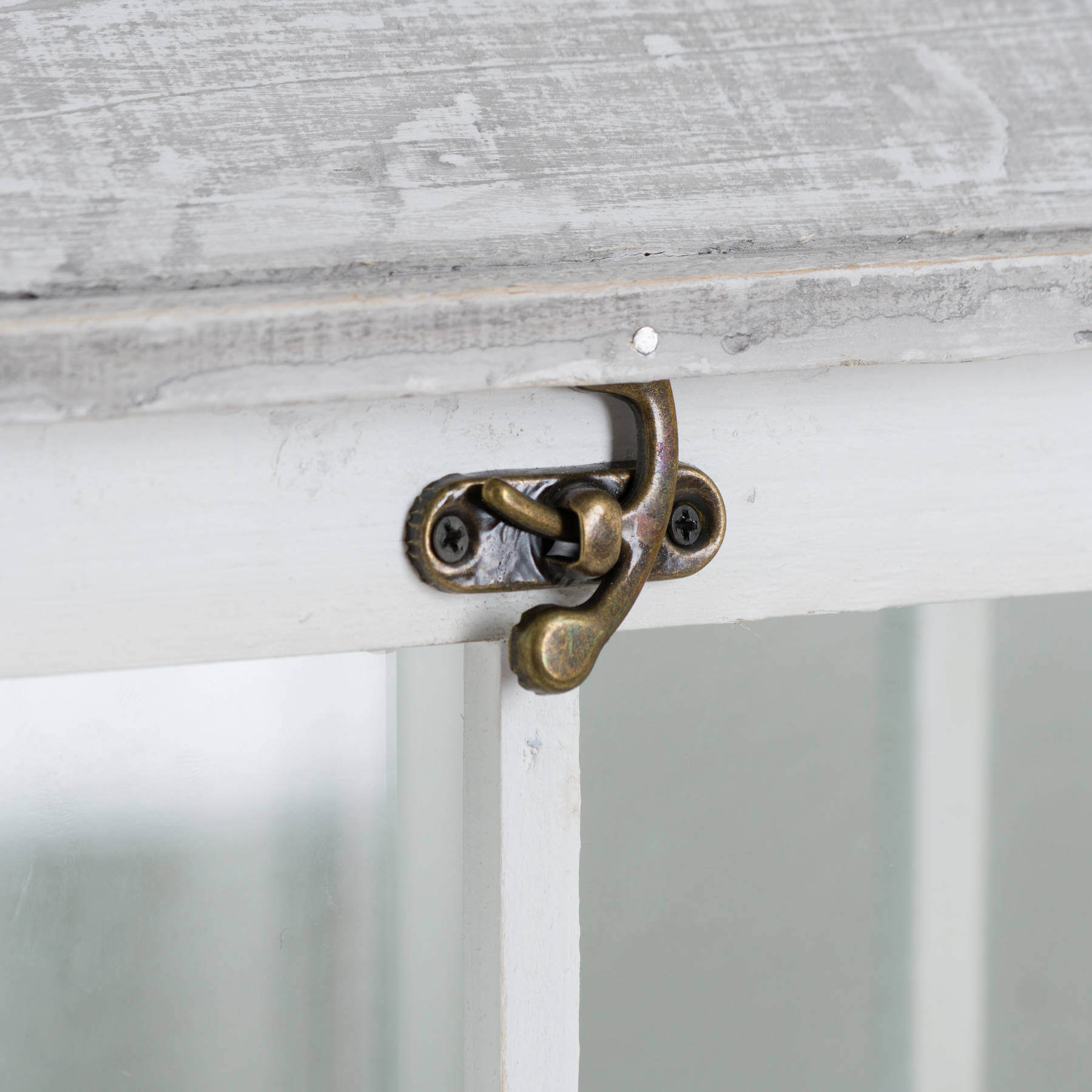 White wooden lantern with intricate window detailing, casting elegant light patterns for coastal or Scandinavian decor. by RoomLondon at brixbailey.com
