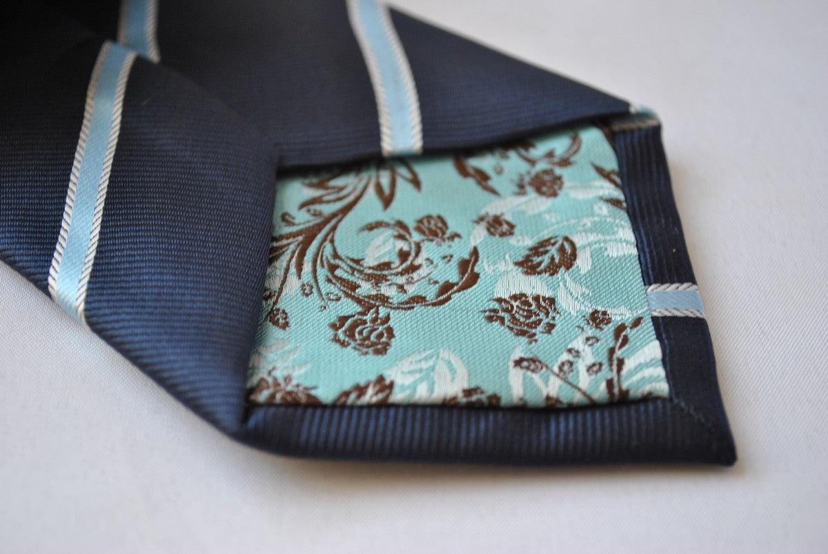 navy blue tie with light blue and white ribbon stripes