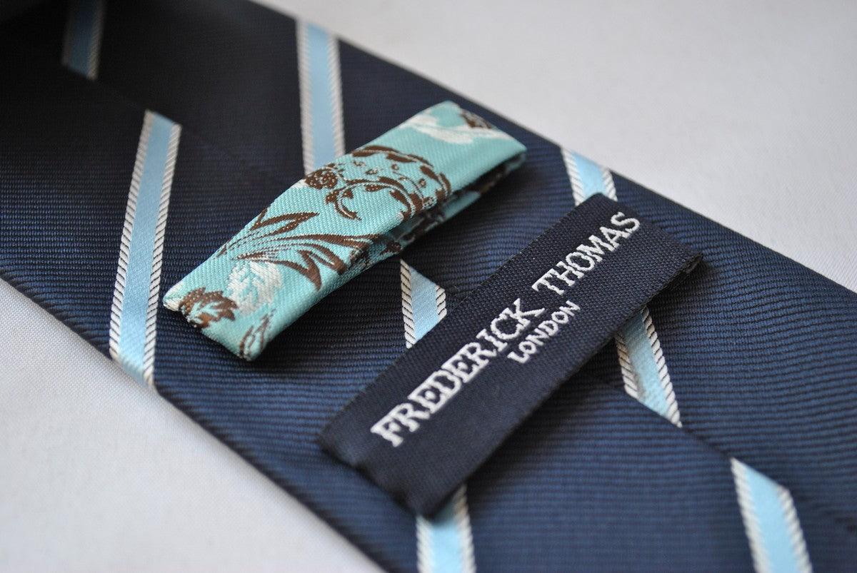 navy blue tie with light blue and white ribbon stripes