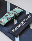 navy blue tie with light blue and white ribbon stripes