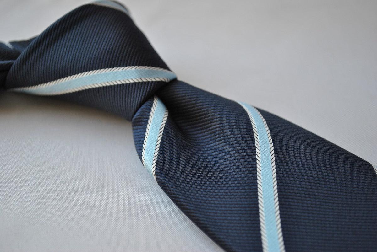 navy blue tie with light blue and white ribbon stripes