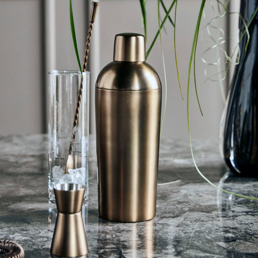 Luxury antique brass barware set, premium stainless steel cocktail shaker, strainer, stirrer, measuring cup, ice bucket, tongs, stylish vintage bar tools by Ella James at brixbailey.com