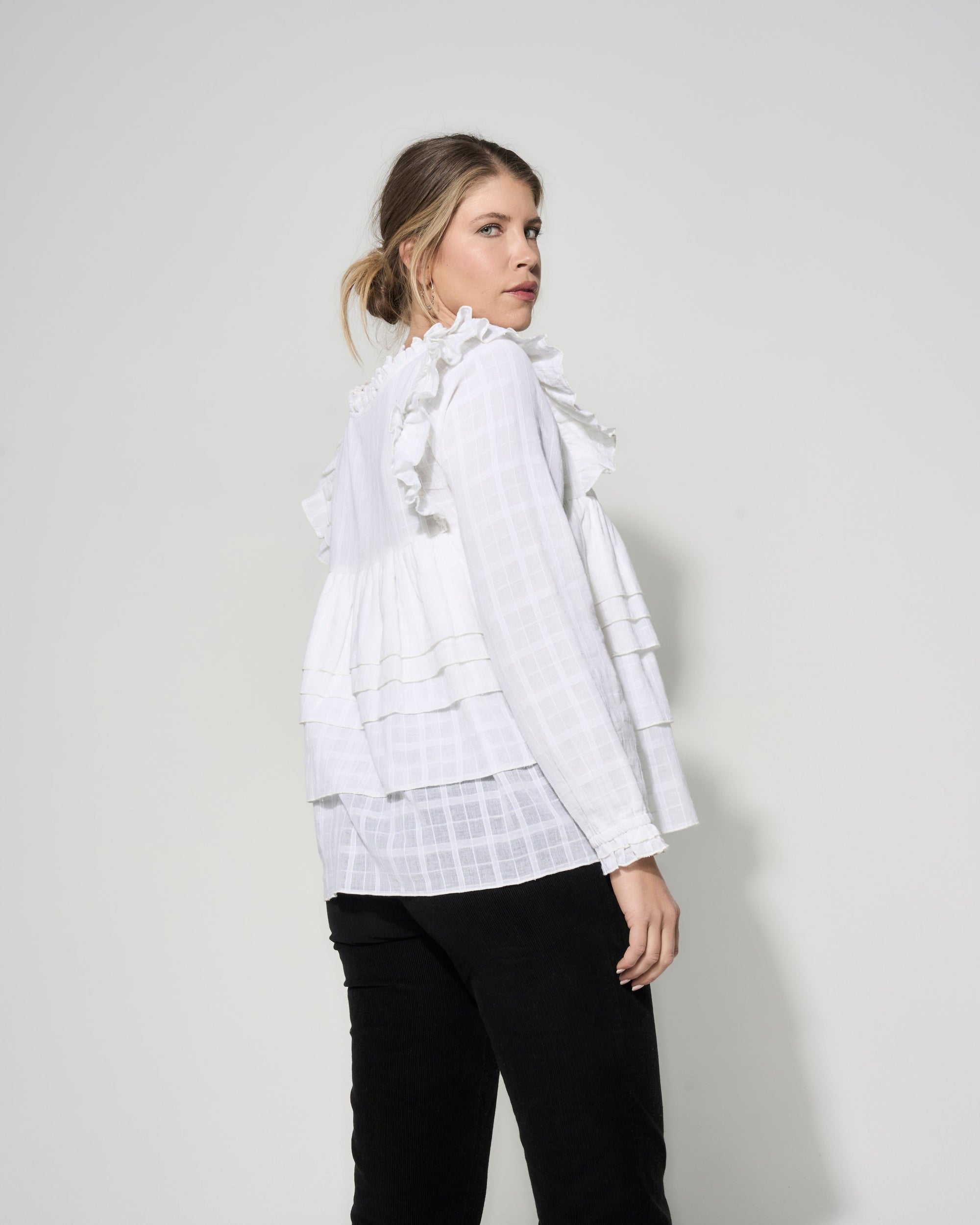 Luxury cream tiered blouse with ruffled shoulders, romantic frilled details, premium textured cotton by GILD at brixbailey.com