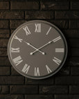 Large grey wall clock with white roman numerals, minimalist metal design, 49cm diameter, modern statement piece by sostter at brixbailey.com