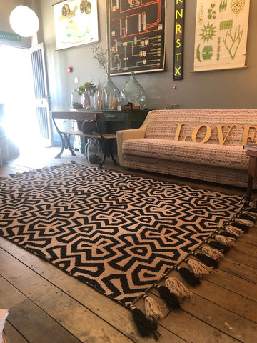 Premium monochrome flat weave wool rug, handmade in India, stylish geometric design with tassels, luxury neutral tones, best-selling by Maria Starling Design at brixbailey.com