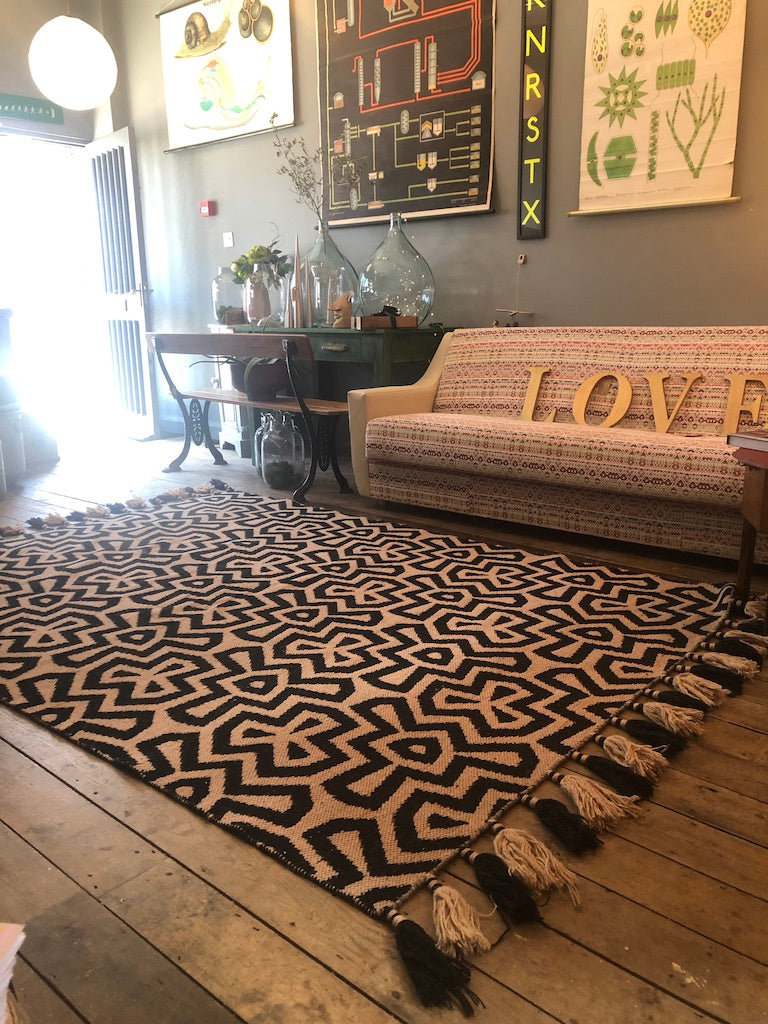 Premium monochrome flat weave wool rug, handmade in India, stylish geometric design with tassels, luxury neutral tones, best-selling by Maria Starling Design at brixbailey.com