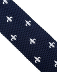 navy blue knitted tie with white embroidered fleur de lis lys design