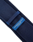 navy blue knitted tie with white embroidered fleur de lis lys design