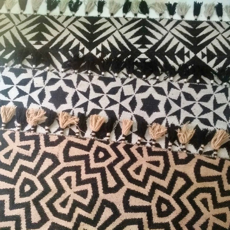 Luxury monochrome flat weave wool rug, handmade in India, stylish geometric design with tassels, premium neutral tones, best-selling by Maria Starling Design at brixbailey.com
