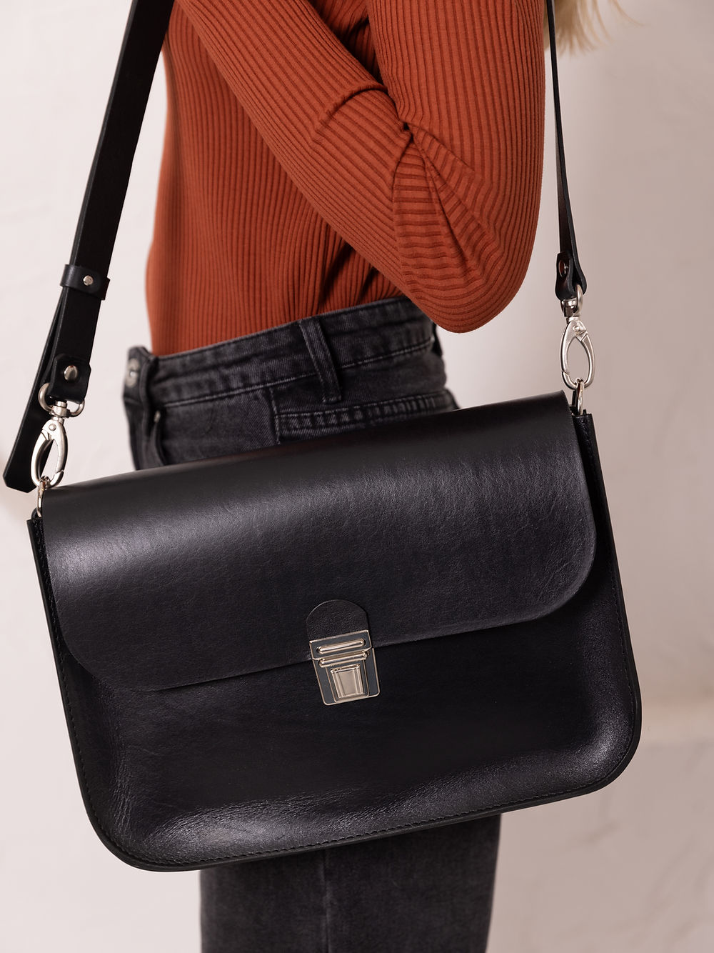 Black Leather Handbag with Buckle Closure