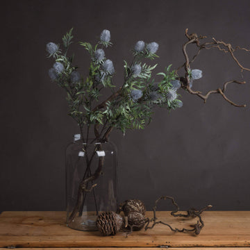 Artificial blue thistle stem with powder-blue petals and lifelike cone, perfect for rustic or coastal floral arrangements by Sostter at brixbailey.com