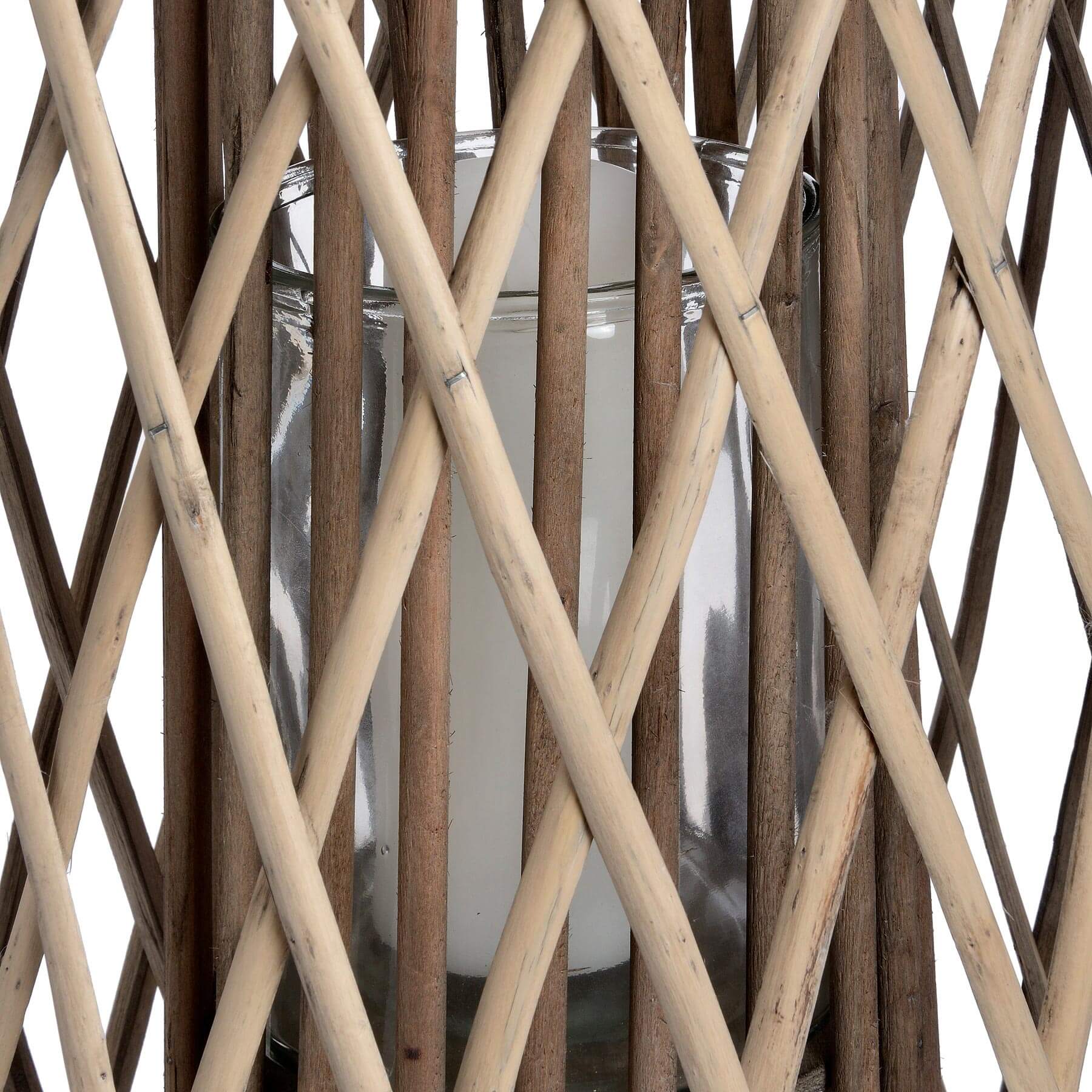 Handwoven wicker lantern with intricate rattan weave, casting warm light patterns, perfect for indoor or outdoor decor. by sostter at brixbailey.com