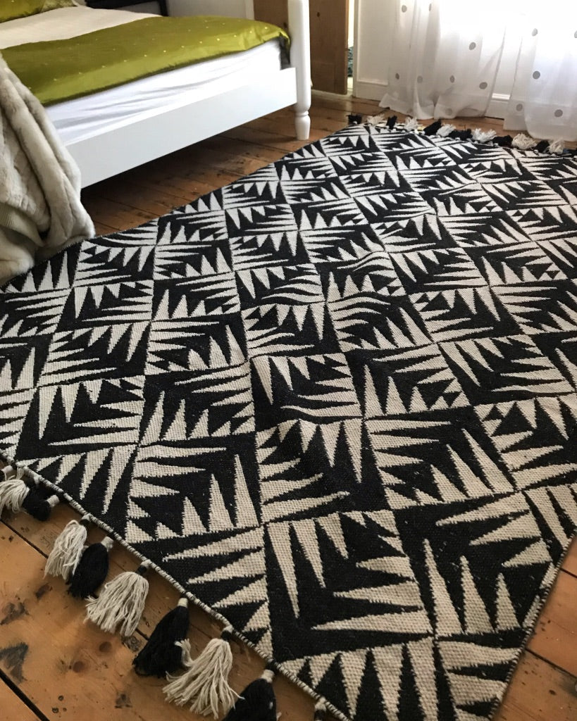 Premium monochrome flat weave wool rug, handmade in India, stylish geometric design with tassels, luxury neutral tones, best-selling by Maria Starling Design at brixbailey.com