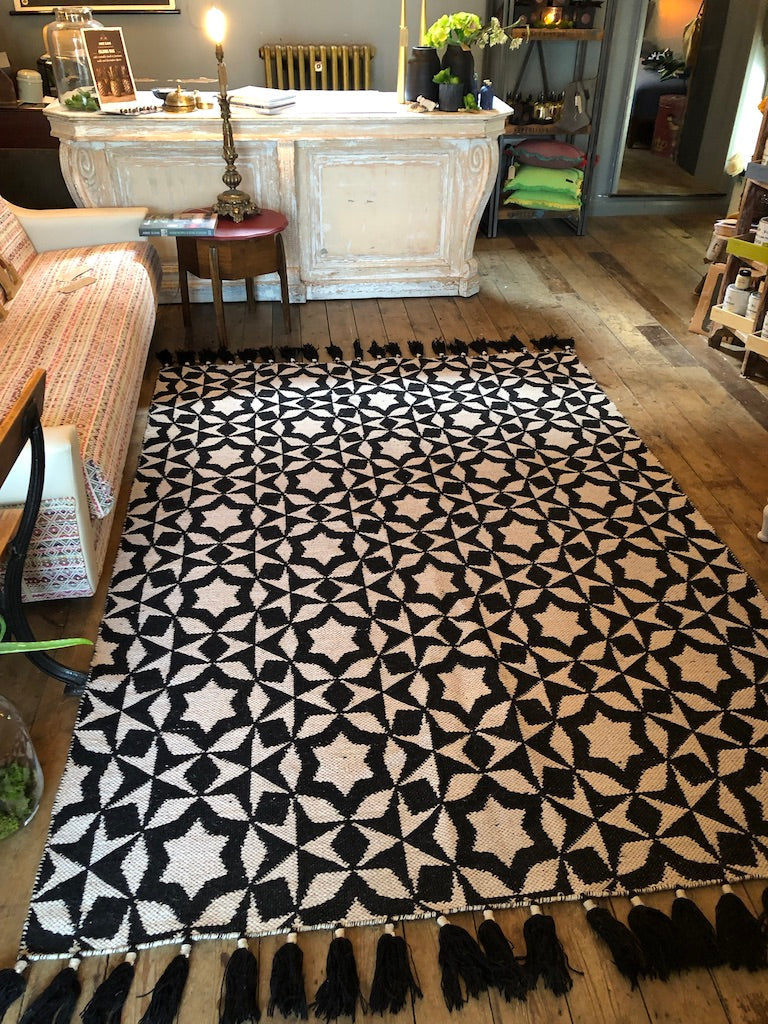 Luxury flat weave monochrome wool rug, handmade in India, stylish geometric design with tassels, best-selling contemporary ethnic decor by Maria Starling Design at brixbailey.com