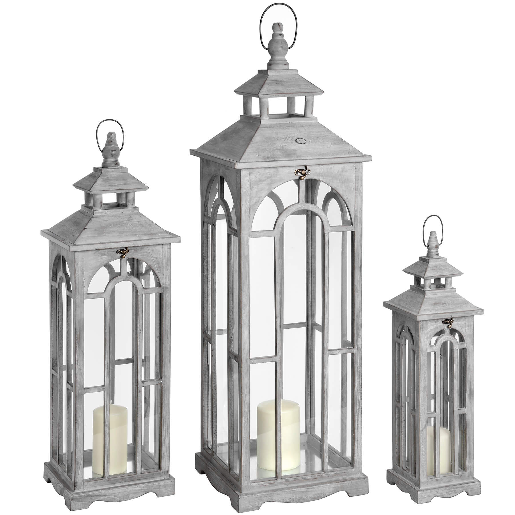 a bold front view of three large white-washed wooden lanterns with archways and brass clasps