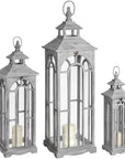 a bold front view of three large white-washed wooden lanterns with archways and brass clasps