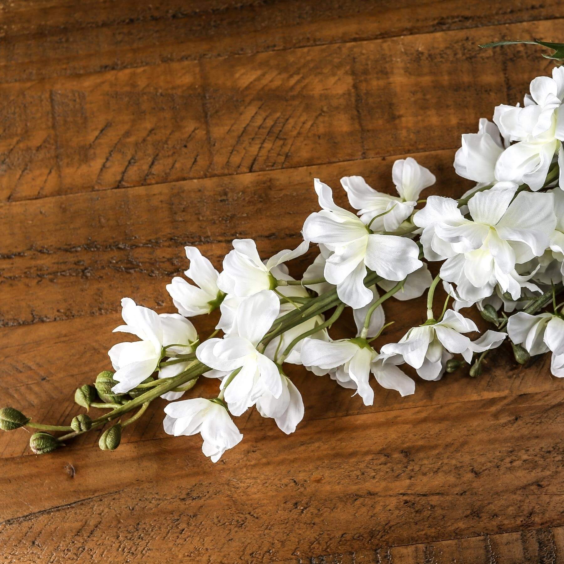 Lifelike white delphinium artificial stem, 84cm tall, with clustered florets for elegant floral arrangements  by sostter at brixbailey.com
