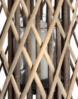 Handwoven rattan lantern with intricate natural weave, rich brown color, casting warm light patterns for indoor or outdoor decor. by sostter at brixbailey.com