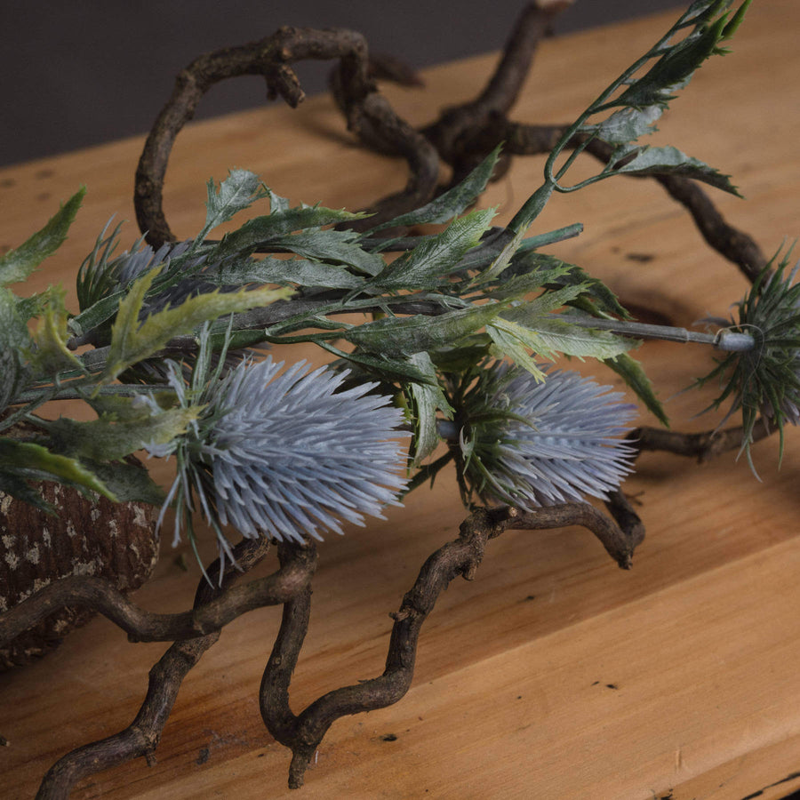 Artificial blue thistle stem with lifelike powder-blue petals and cone, 76cm tall, perfect for rustic or coastal decor by Sostter at brixbailey.com