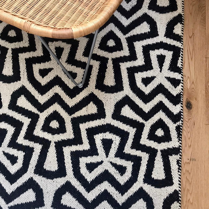 Luxury monochrome flat weave wool rug, handmade in India, stylish geometric design with tassels, best-selling neutral tone decor by Maria Starling Design at brixbailey.com