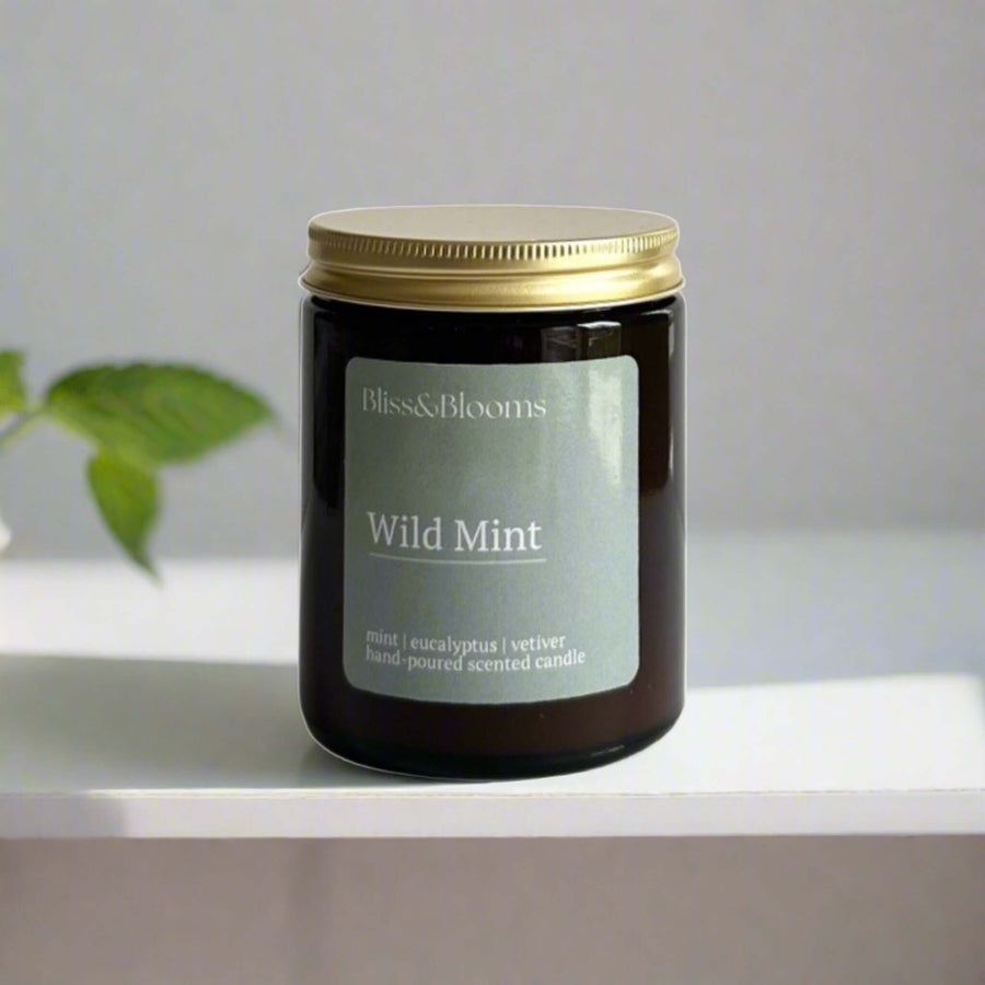 Luxury wild mint scented candle with peppermint, eucalyptus, lemon, handcrafted in amber glass jar, premium home fragrance, 35-hour burn time by Bliss & Blooms at brixbailey.com