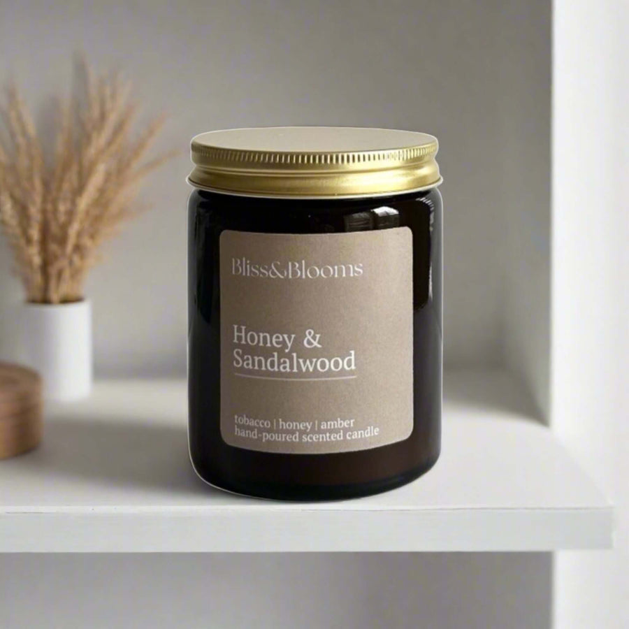 Luxury honey sandalwood scented candle, handcrafted premium soy wax in amber glass jar with gold lid, warm woody fragrance, 35-hour burn time by Bliss & Blooms at brixbailey.com